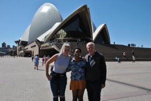 Briana Mitchell and Britta Andress pose with sociology alum Mark Johnson (Class of 1975) in front of the Sydney Opera House as they get ready to take on the island of Tanna, Vanuatu.